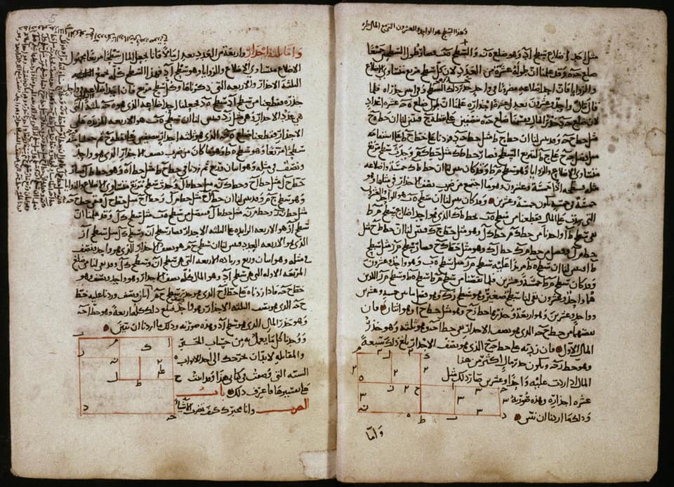 Two facing pages of an old Arabic manuscript on yellowed, stained paper, each filled with lines of close black handwriting, with a few words in red and dense notes squeezed into the left margin. Near the foot of each page is a small diagram drawn in red ink: squares and rectangles divided into smaller parts and marked with Arabic letters, the geometric proofs of two quadratic equations.