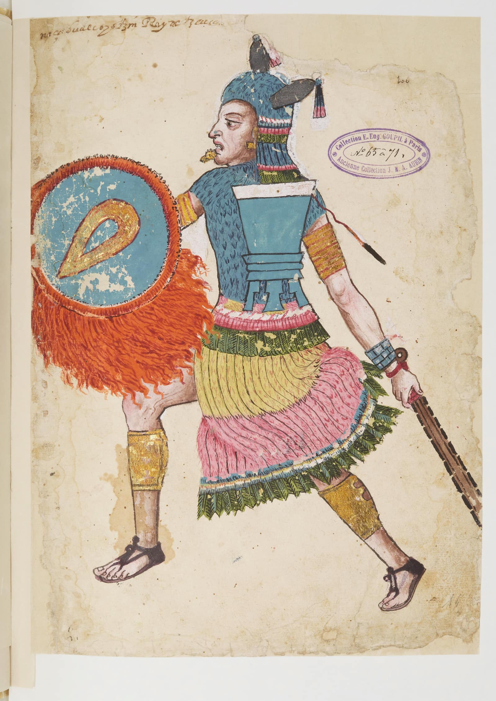 A painted manuscript page, stained and worn at the edges: a man in profile strides to the left, dressed as a warrior in a blue feathered tunic with a pink, yellow and green feathered skirt, gold bands on his arms and shins, a gold lip plug, holding a round blue shield fringed with red feathers and a wooden club edged with dark blades. A short handwritten caption runs across the top, and a purple library stamp is printed at upper right.